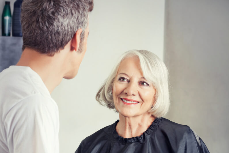 woman consults with her hair replacement stylist